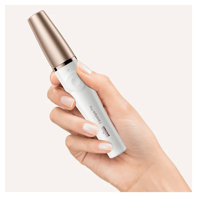 Braun FaceSpa Pro device, white with rose gold accent, held by a hand.