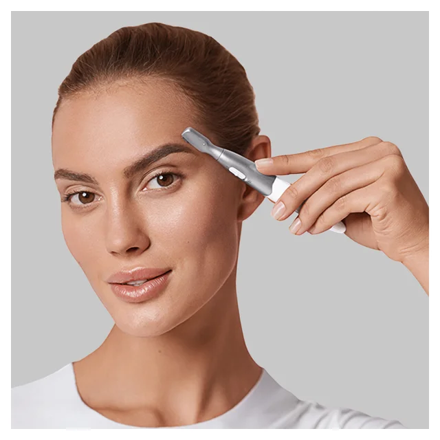 Braun eyebrow trimmer used by a woman for precise eyebrow shaping.