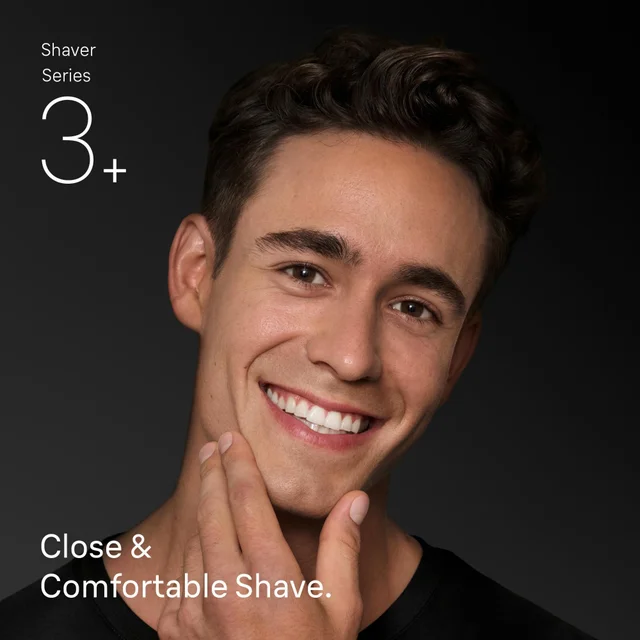 Man smiling, touching smooth face, demonstrating Braun's 'Close & Comfortable Shave'.