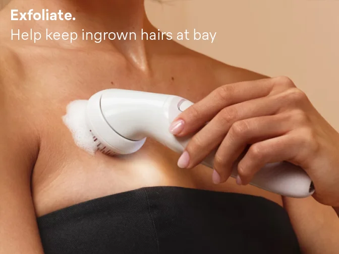 Woman using exfoliating head on chest area. Help keep ingrown hairs at bay.