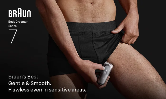 Bottom half of man's torso using Braun Body Groomer Series 7 to trim hair in groin area. Gentle even in sensitive areas.