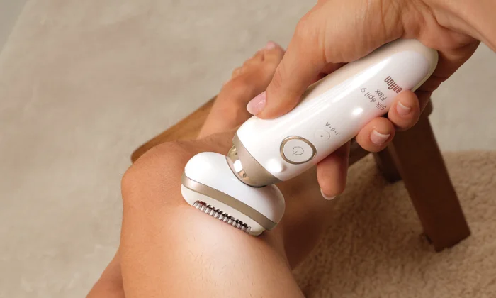 Braun Silk Epil 9 Flex being used on leg