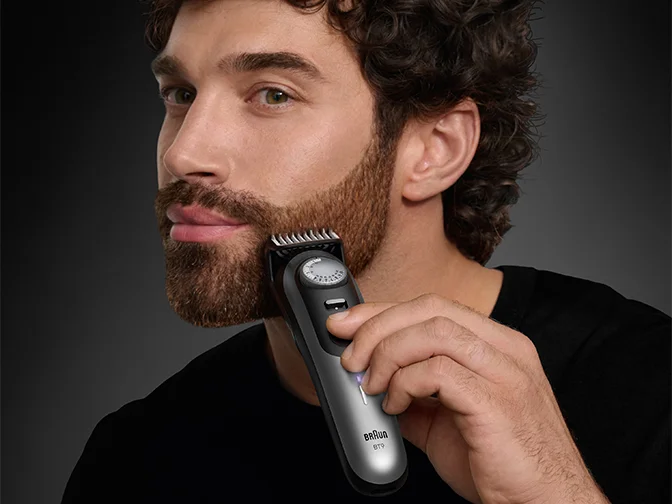 Beard Trimmers - Braun - man using beard trimmer to shape his beard